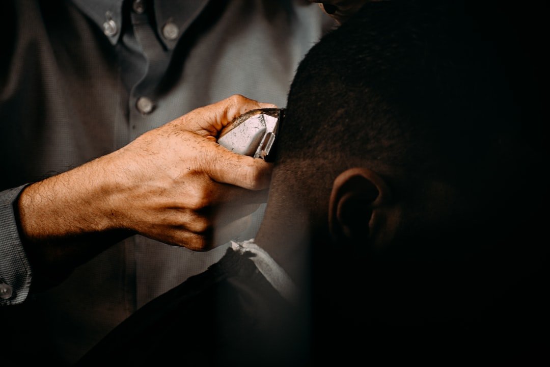 a-man-in-a-suit-holding-a-pen-to-a-mans-ear-wvquufhu694